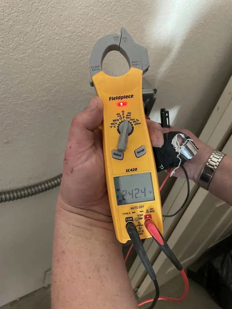 Voltage testing with clamp meter during Ceiling Fan Installation in Osceola